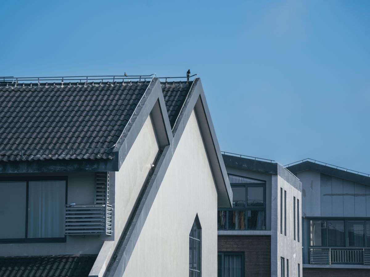 Clean residential roofline with clear gutters and exterior siding